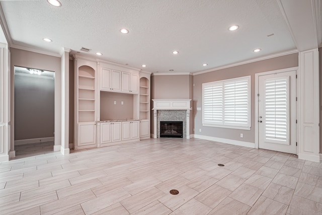 unfurnished living room with visible vents, baseboards, recessed lighting, ornamental molding, and a textured ceiling