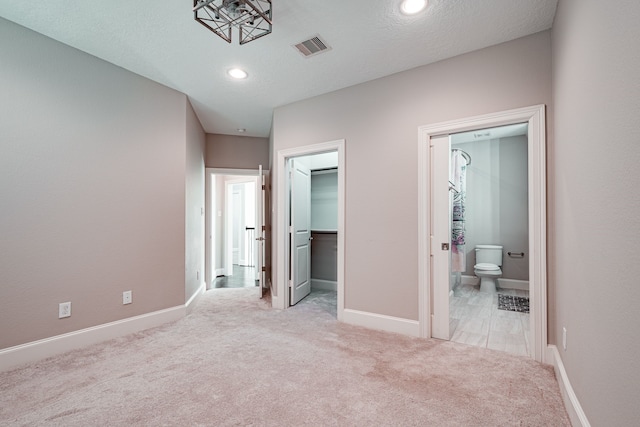 unfurnished bedroom with carpet, visible vents, and baseboards