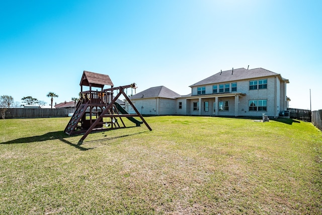 view of yard with a fenced backyard and a playground