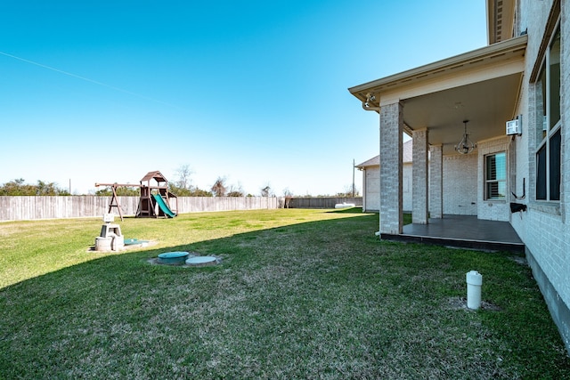 view of yard with a playground and a fenced backyard