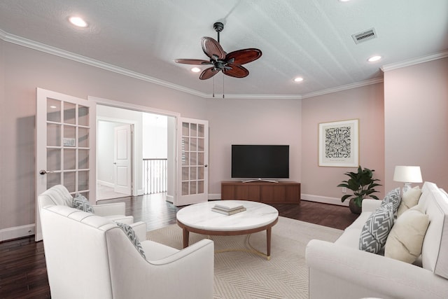 living room featuring visible vents, dark wood-style floors, a ceiling fan, and ornamental molding