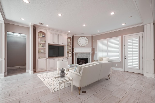 living room featuring a glass covered fireplace, recessed lighting, a textured ceiling, and crown molding