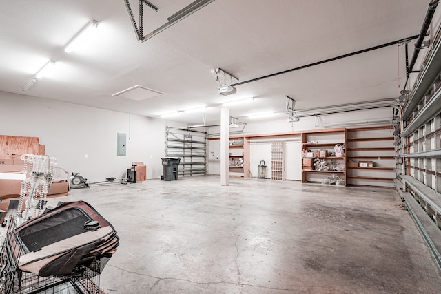 garage with electric panel and a garage door opener