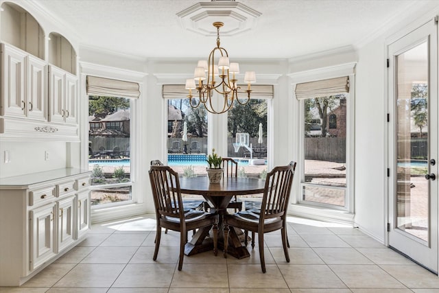 dining area with ornamental molding, light tile patterned flooring, and a chandelier