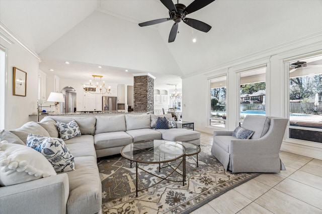 living room featuring light tile patterned floors, ceiling fan with notable chandelier, arched walkways, and high vaulted ceiling