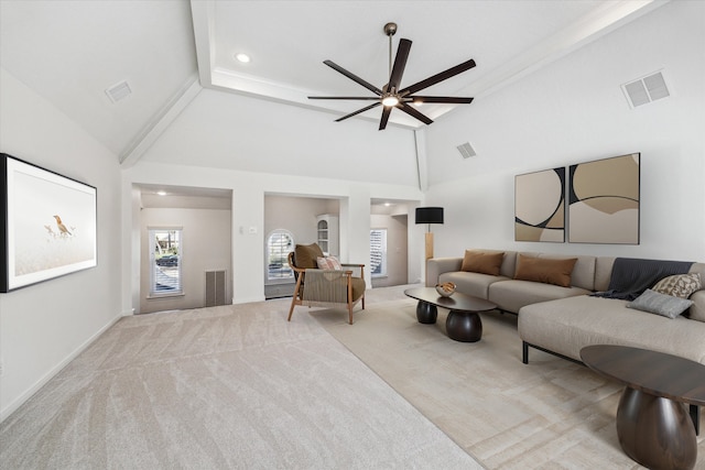 carpeted living room featuring visible vents and high vaulted ceiling