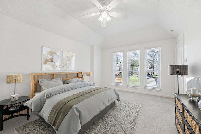 bedroom with carpet flooring, baseboards, a ceiling fan, and vaulted ceiling