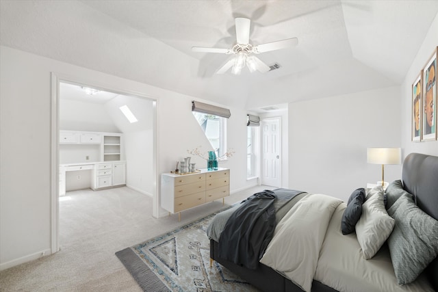 bedroom with vaulted ceiling, baseboards, visible vents, and light carpet