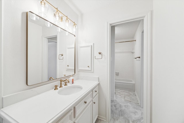 bathroom with marble finish floor, vanity, shower / bath combination, and baseboards