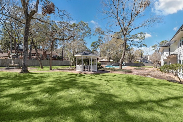 view of yard featuring a gazebo, a fenced in pool, and fence