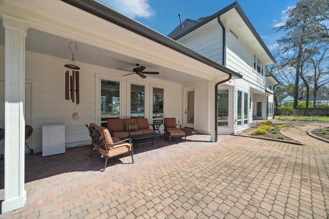 view of patio featuring an outdoor living space, french doors, and ceiling fan