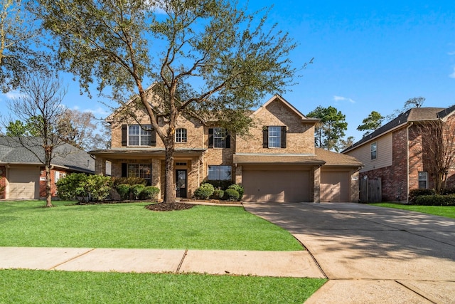 traditional-style house with driveway, brick siding, an attached garage, and a front yard