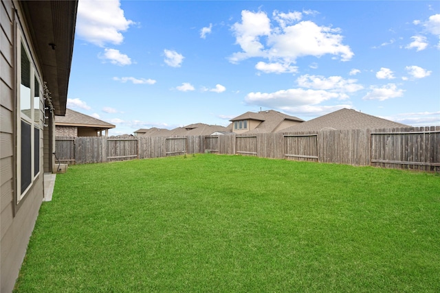 view of yard with a fenced backyard