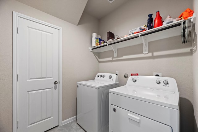 laundry area with baseboards, laundry area, and washer and clothes dryer