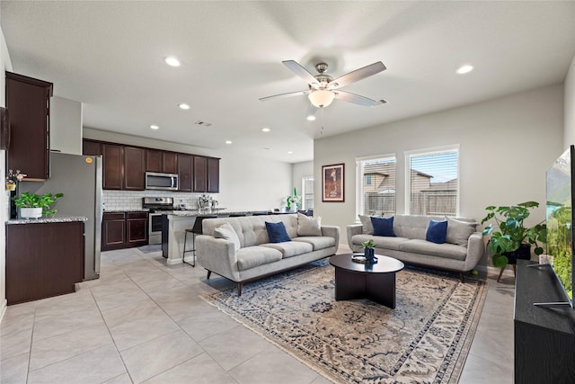 living room with light tile patterned floors, recessed lighting, visible vents, and ceiling fan