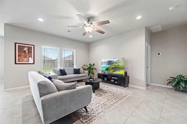 living room featuring light tile patterned flooring, visible vents, recessed lighting, and baseboards