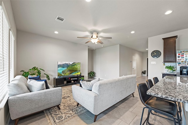 living area featuring light tile patterned floors, visible vents, recessed lighting, and a ceiling fan