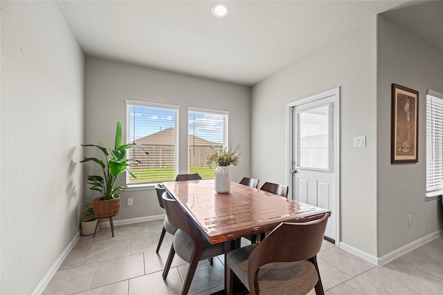 dining space featuring light tile patterned floors and baseboards