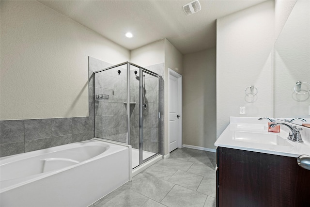 bathroom with visible vents, a shower stall, a garden tub, and a sink