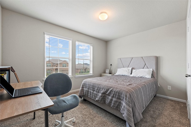 bedroom featuring carpet and baseboards