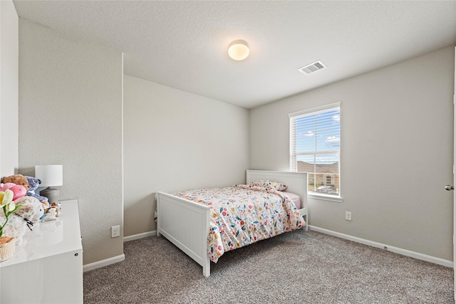 bedroom featuring visible vents, baseboards, and carpet