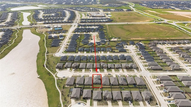 birds eye view of property featuring a residential view and a water view