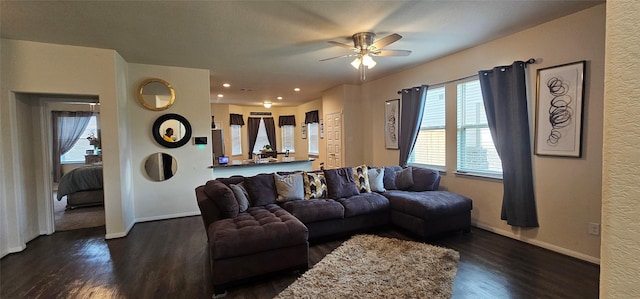 living area featuring recessed lighting, ceiling fan, baseboards, and dark wood-style flooring