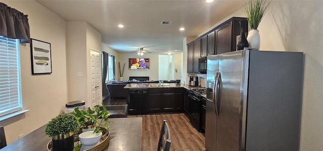 kitchen with visible vents, dark wood-style flooring, ceiling fan, black appliances, and open floor plan