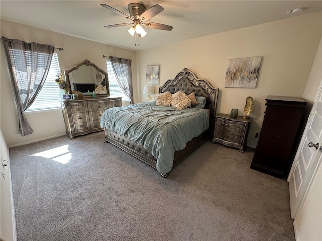 carpeted bedroom featuring baseboards and ceiling fan