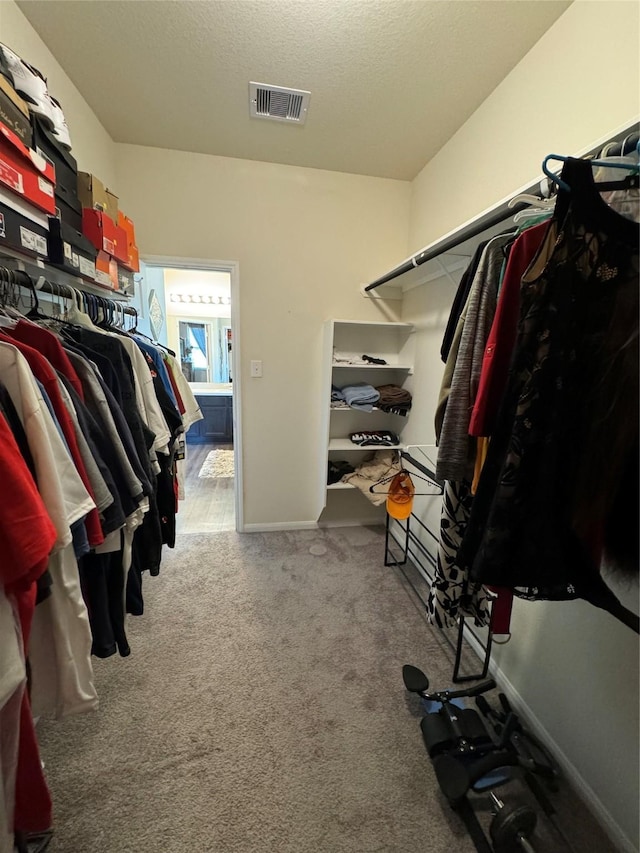 spacious closet featuring visible vents and carpet