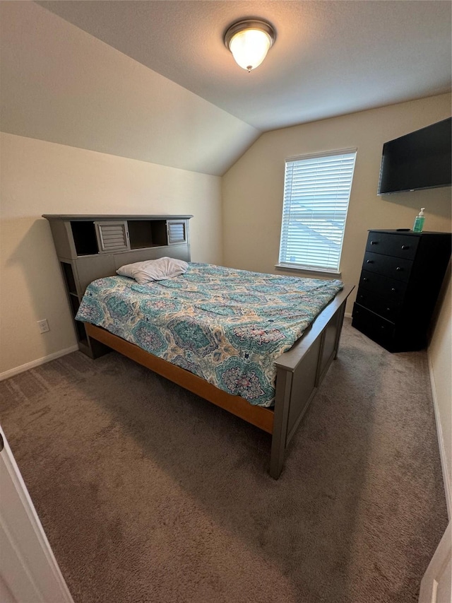 bedroom featuring baseboards, carpet, and vaulted ceiling