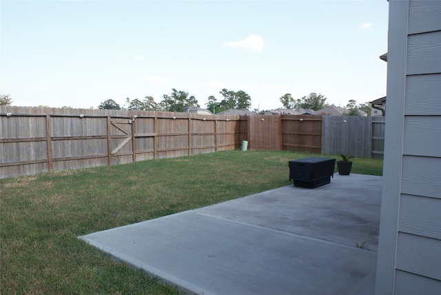 view of yard with a fenced backyard and a patio