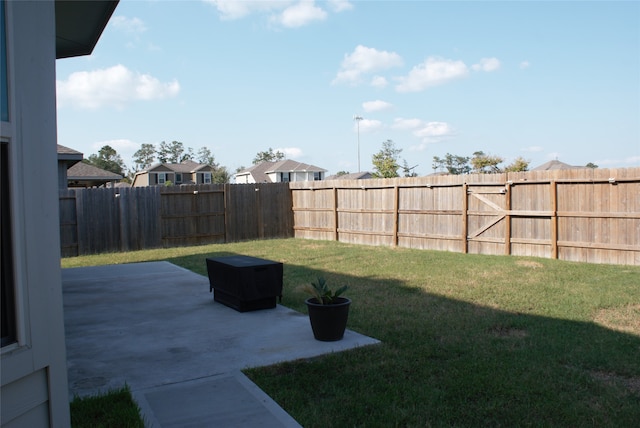 view of yard featuring a patio area and a fenced backyard