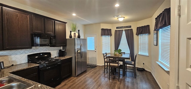 kitchen featuring backsplash, baseboards, dark brown cabinetry, dark wood finished floors, and black appliances