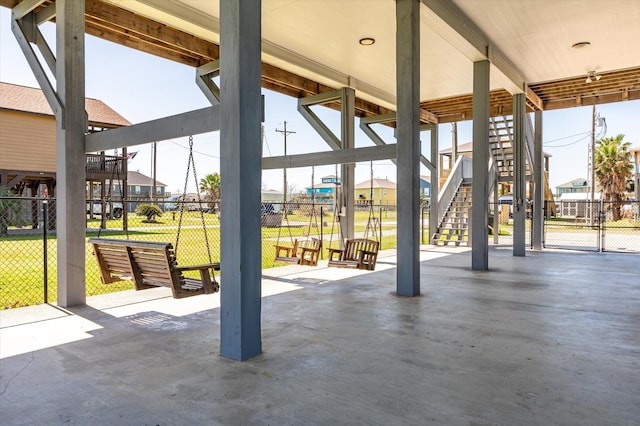 view of patio / terrace featuring a residential view, stairs, and fence