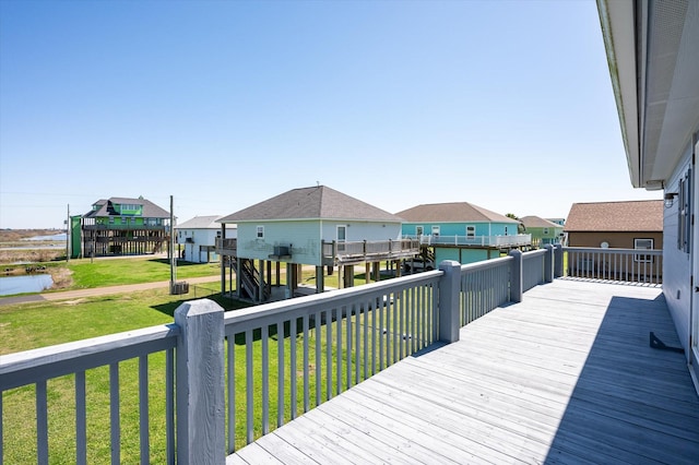 deck with a yard and a residential view