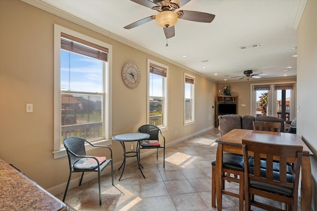 dining room featuring visible vents, a healthy amount of sunlight, and ornamental molding