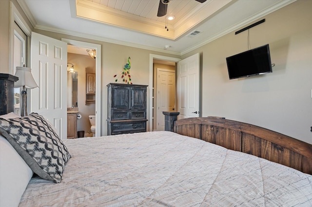 bedroom featuring a tray ceiling, visible vents, and ornamental molding