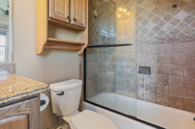 bathroom featuring shower / bath combination with glass door, toilet, and vanity