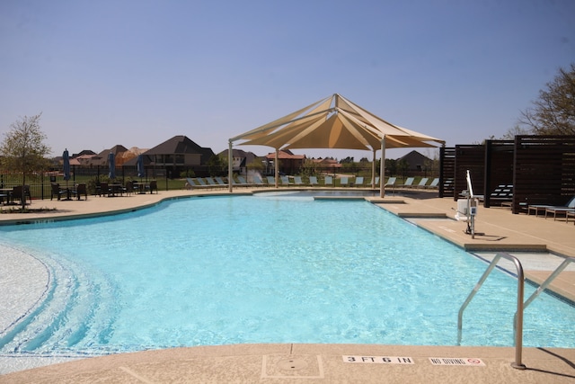 pool featuring a patio and fence