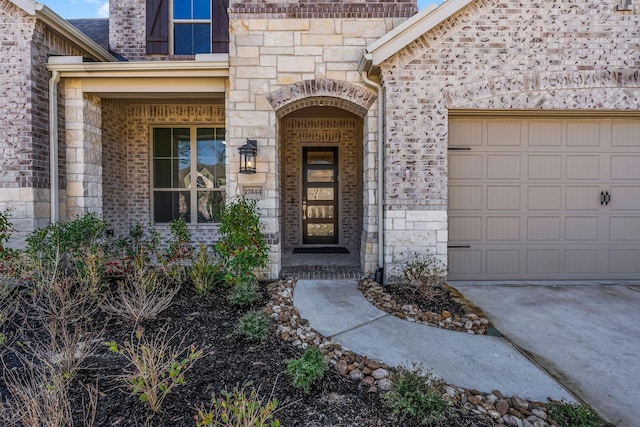 doorway to property with a garage and stone siding