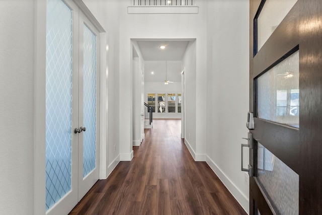 hall with french doors, baseboards, and dark wood-style flooring