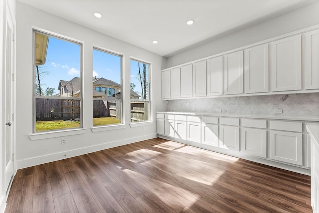 interior space with dark wood-type flooring, recessed lighting, and baseboards