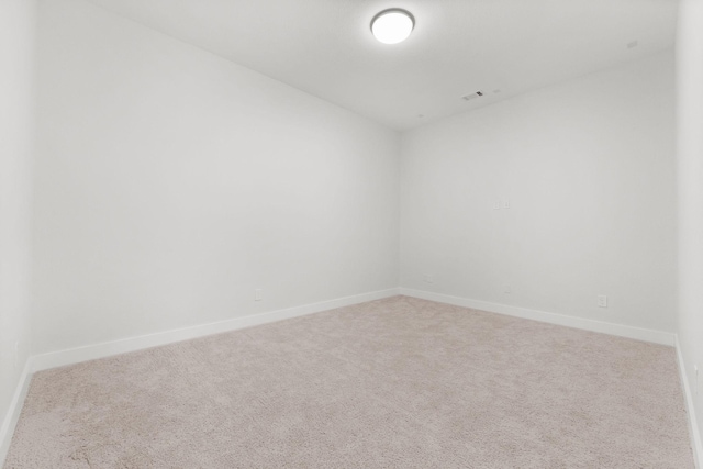 spare room with baseboards, visible vents, and carpet floors