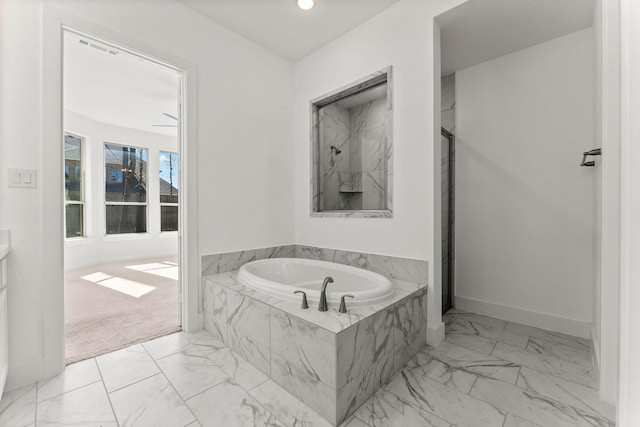 full bath featuring a garden tub, marble finish floor, recessed lighting, baseboards, and walk in shower