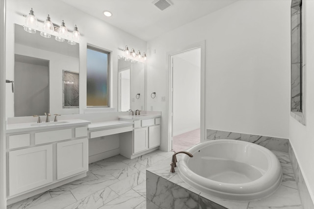 bathroom featuring visible vents, a garden tub, two vanities, marble finish floor, and a sink