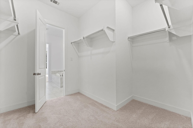 walk in closet with visible vents and carpet flooring