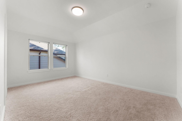 carpeted spare room with baseboards