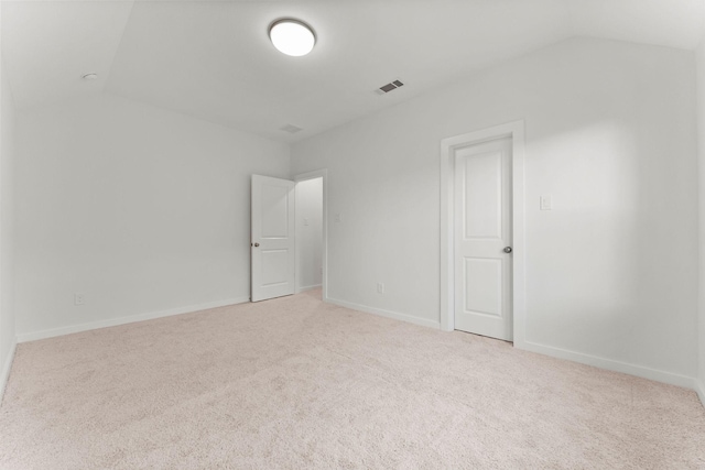 unfurnished room featuring vaulted ceiling, carpet flooring, and baseboards