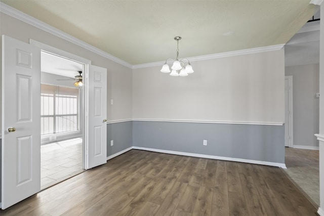 unfurnished room with baseboards, ceiling fan with notable chandelier, wood finished floors, and ornamental molding